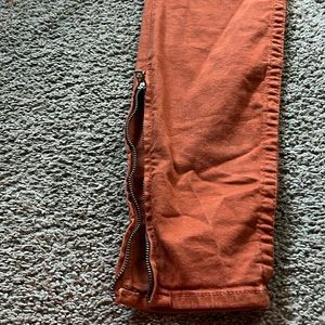 Burnt orange women true religion jeans with zipper on pants legs